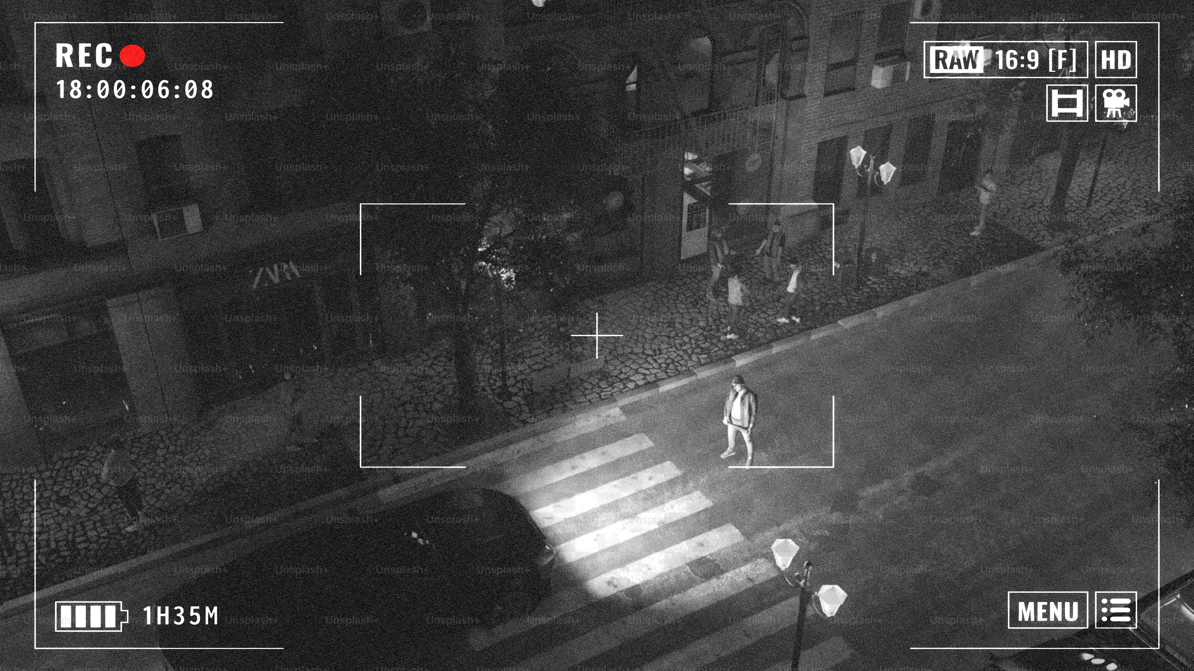 Night vision camera view of city street.